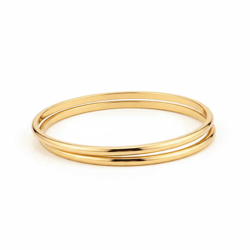 Set of three minimal gold plated stacked bangles on white background